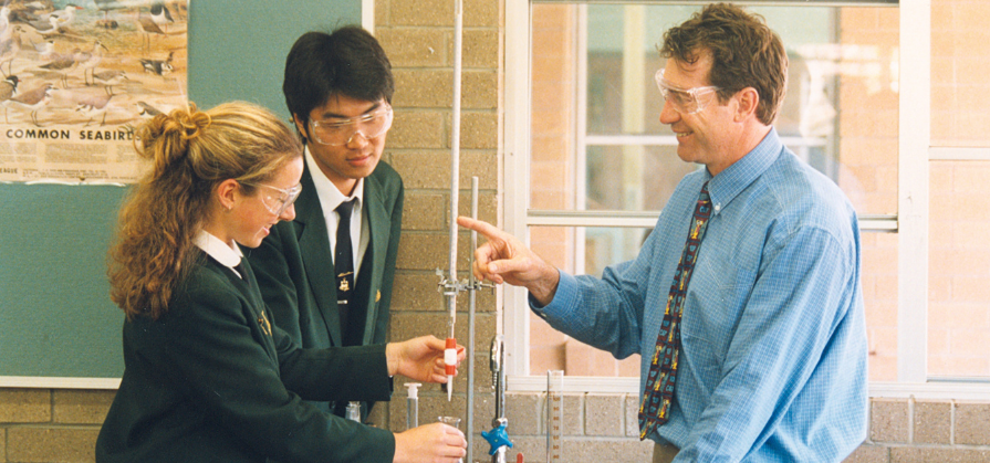 Teacher Phil Knox with students doing a science experiment