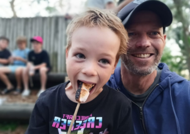 Father and son enjoying roasted marshmallows at Father & Children's Camp